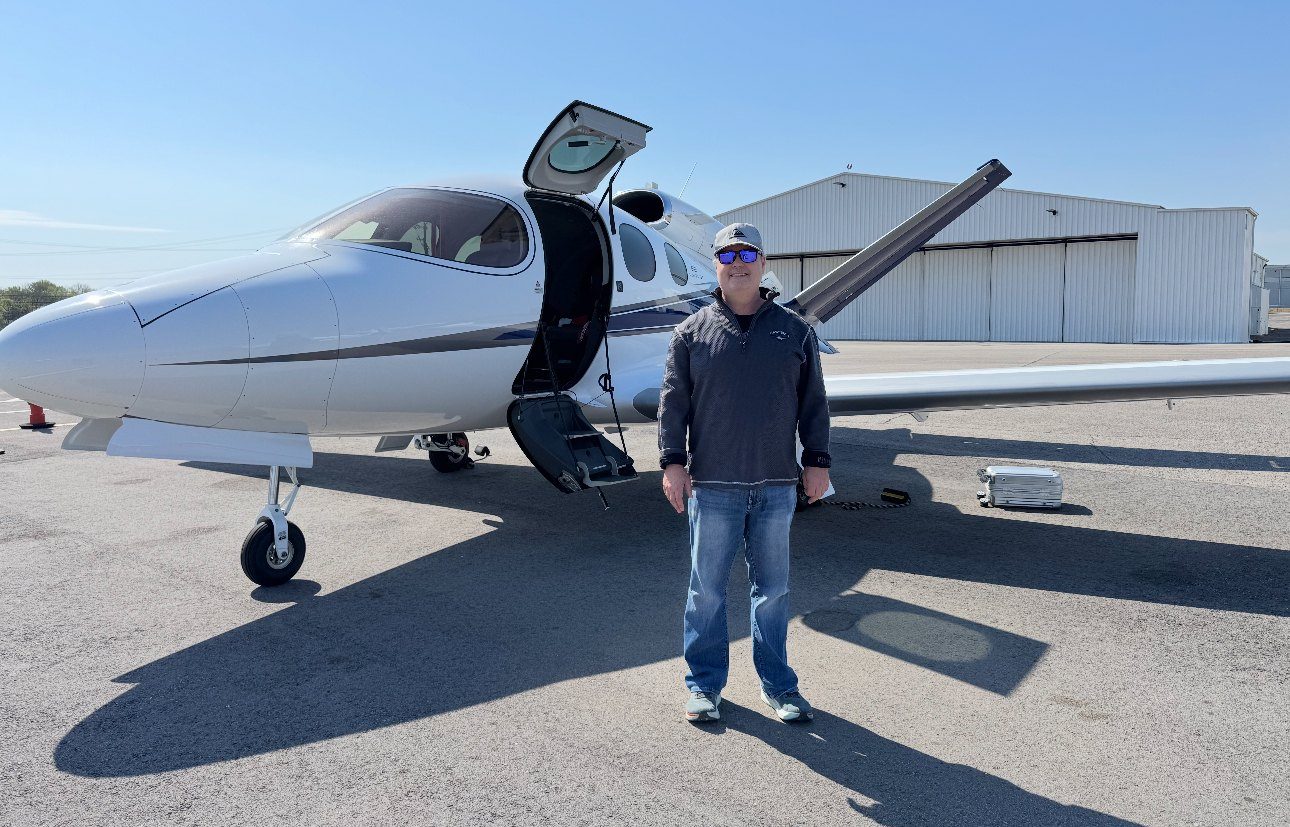 Jay Hirshberg standing beside his Cirrus Vision Jet on the ramp